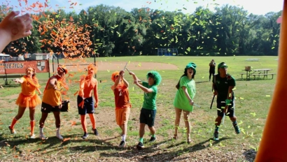 Campers throwing conetti into the sky.
