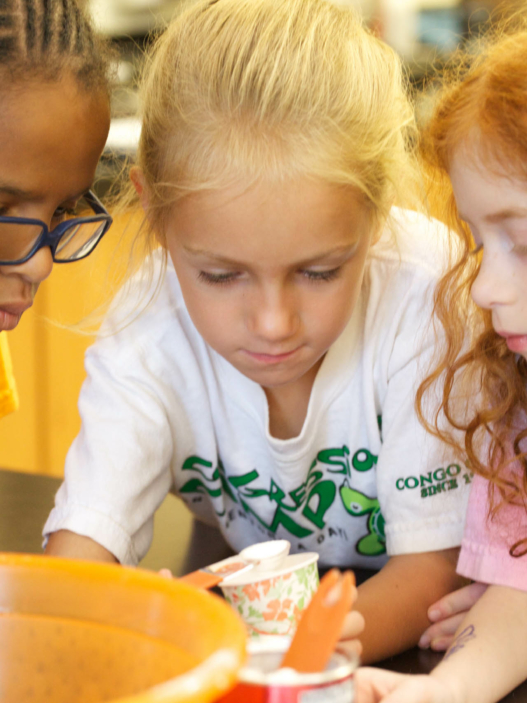 Three campers working on a project together.